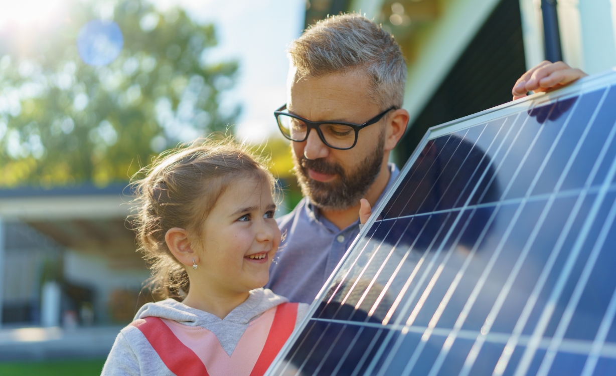 father and daughter view solar panel