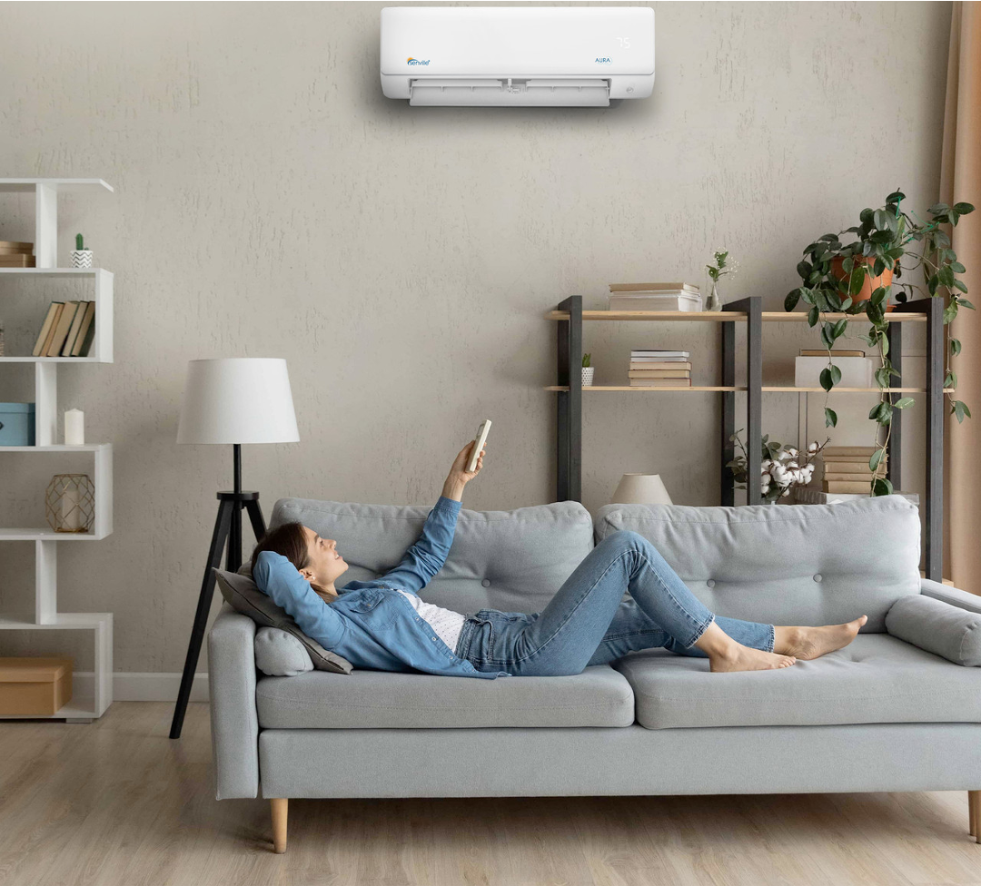Woman reclines on couch with A/C remote
